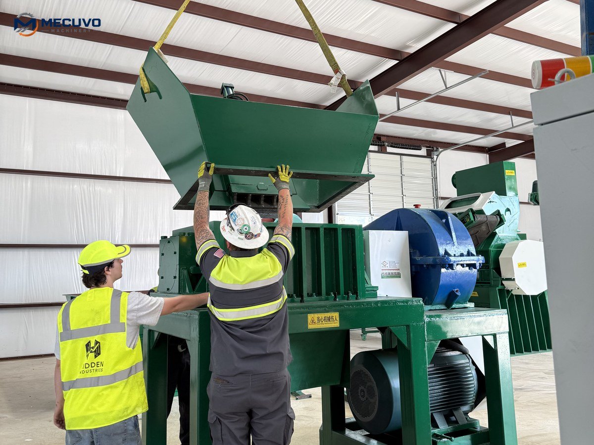 Operators and technicians conducting handover and commissioning checks beside a copper granulator