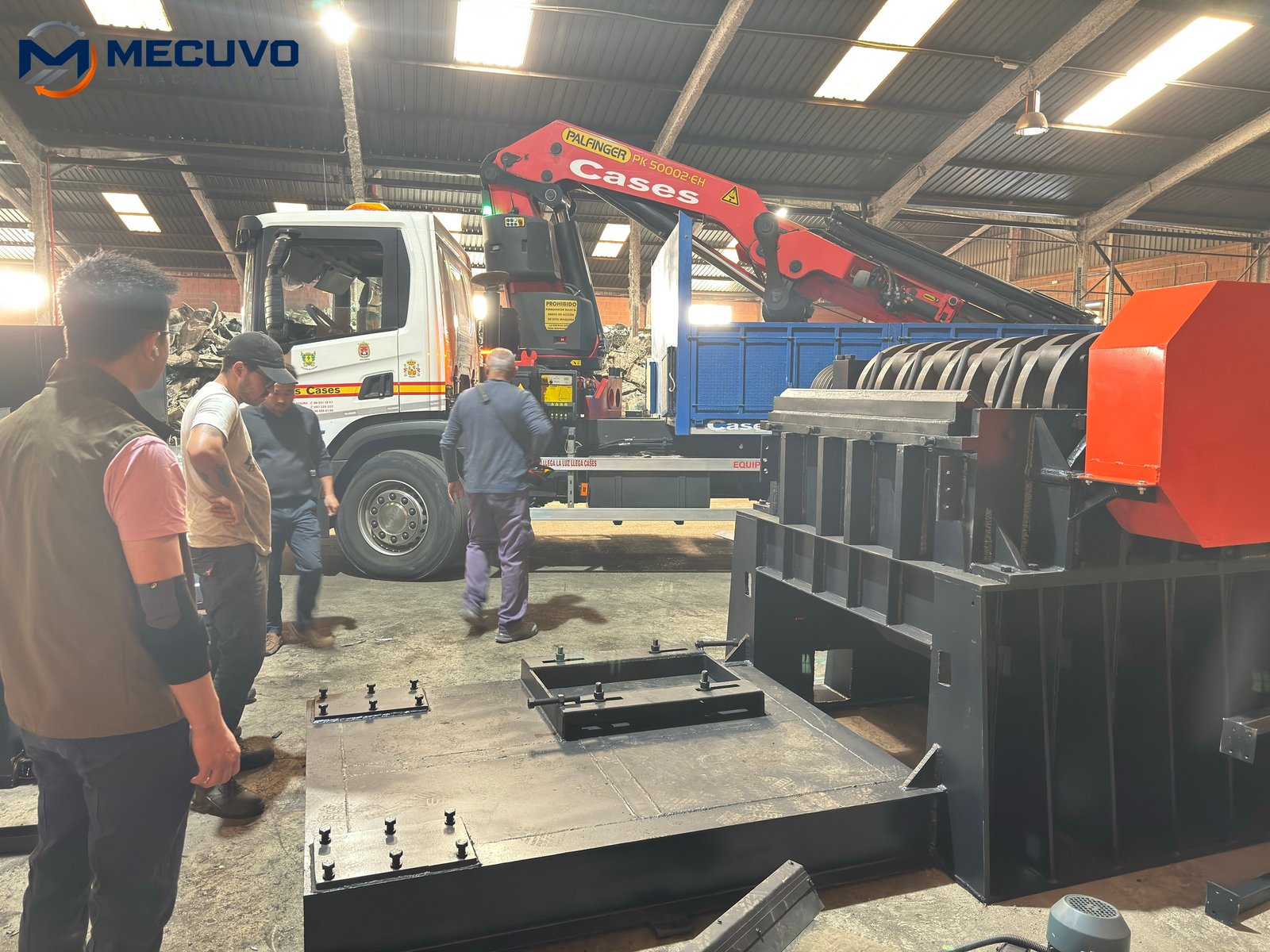 Personnel working alongside an installed radiator recycling line Technicians and heavy equipment at a radiator recycling installation
