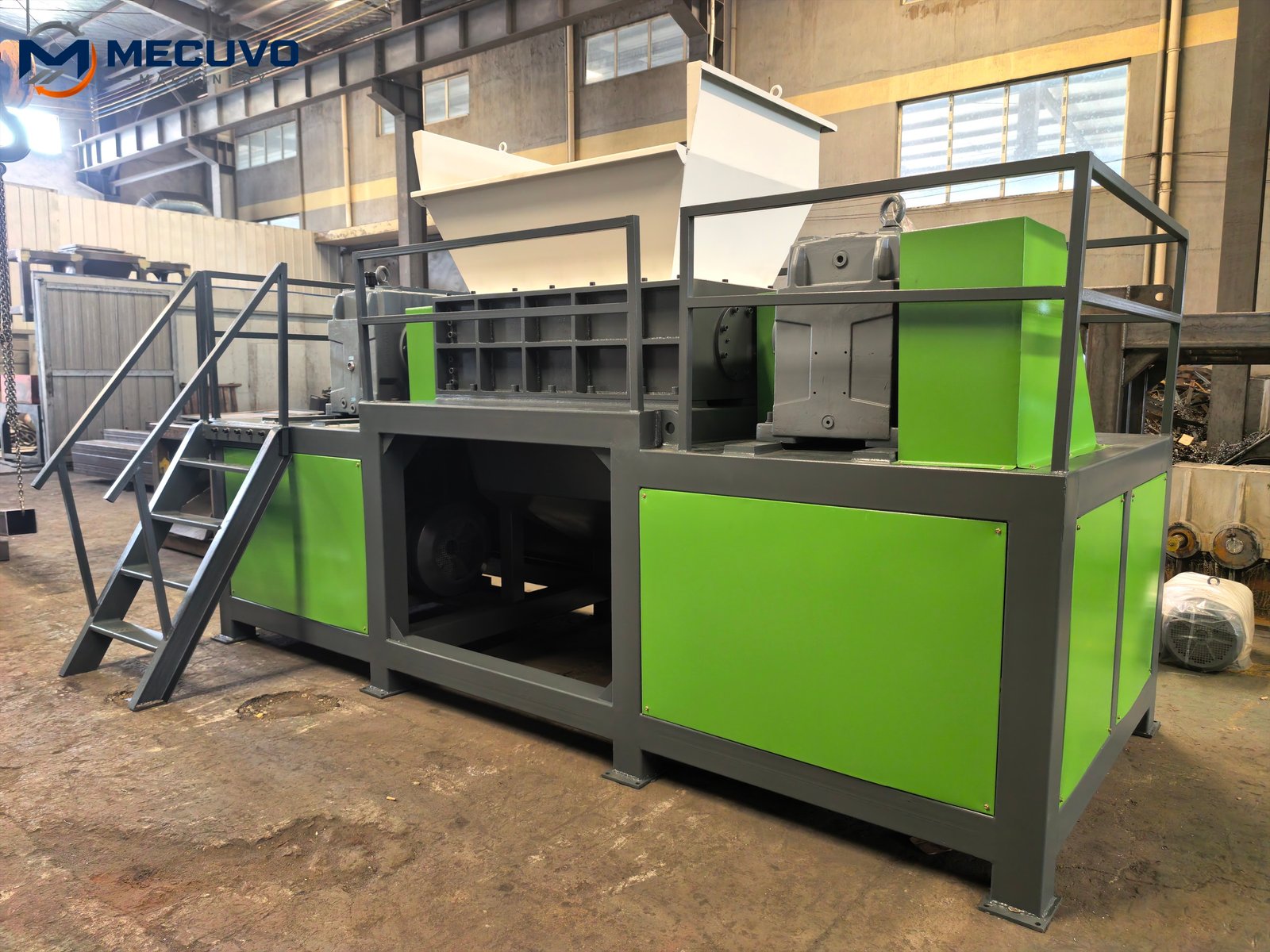 Complete green industrial dual shaft shredder with hopper and access stairs