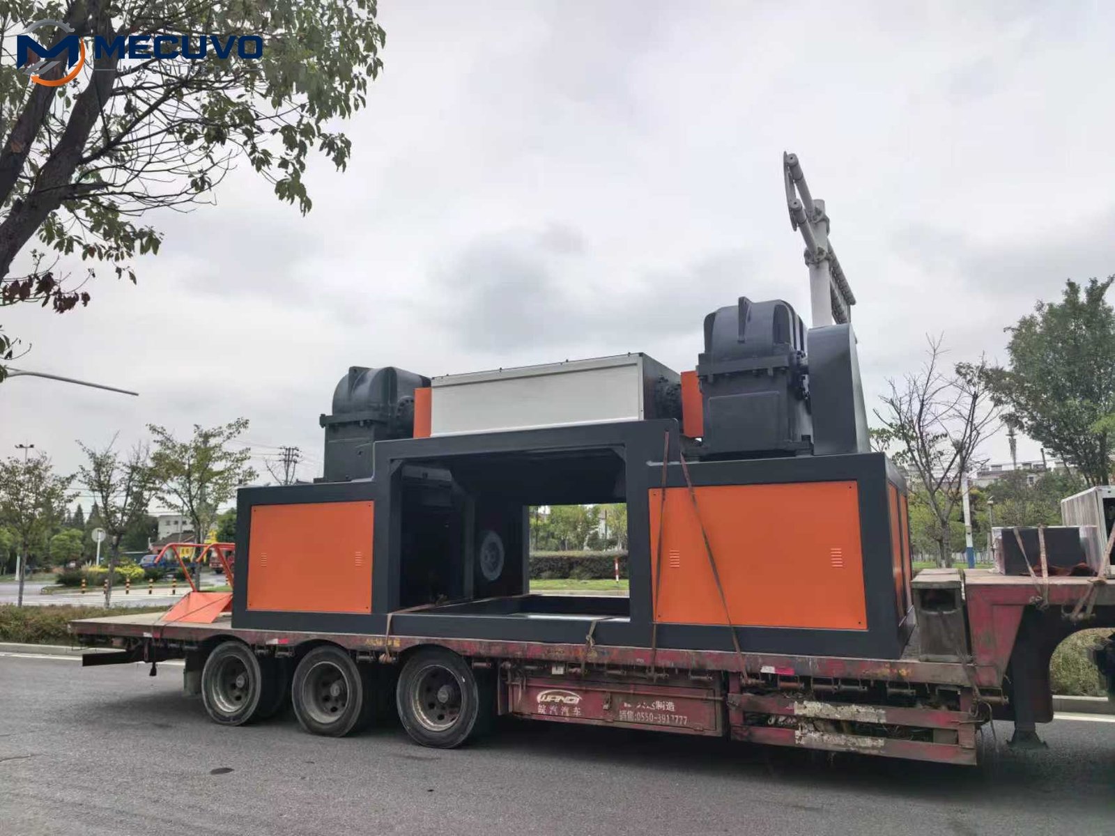 Heavy shredder loaded on a transport trailer for shipment