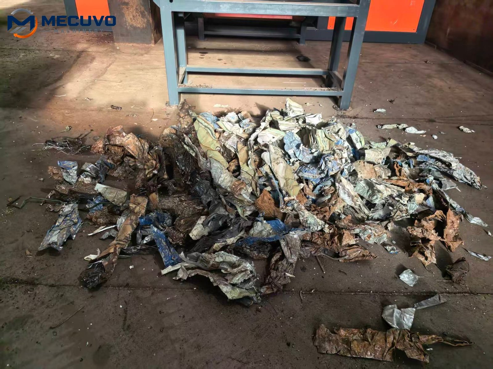 Size reduced mixed metal discharged beneath a conveying system