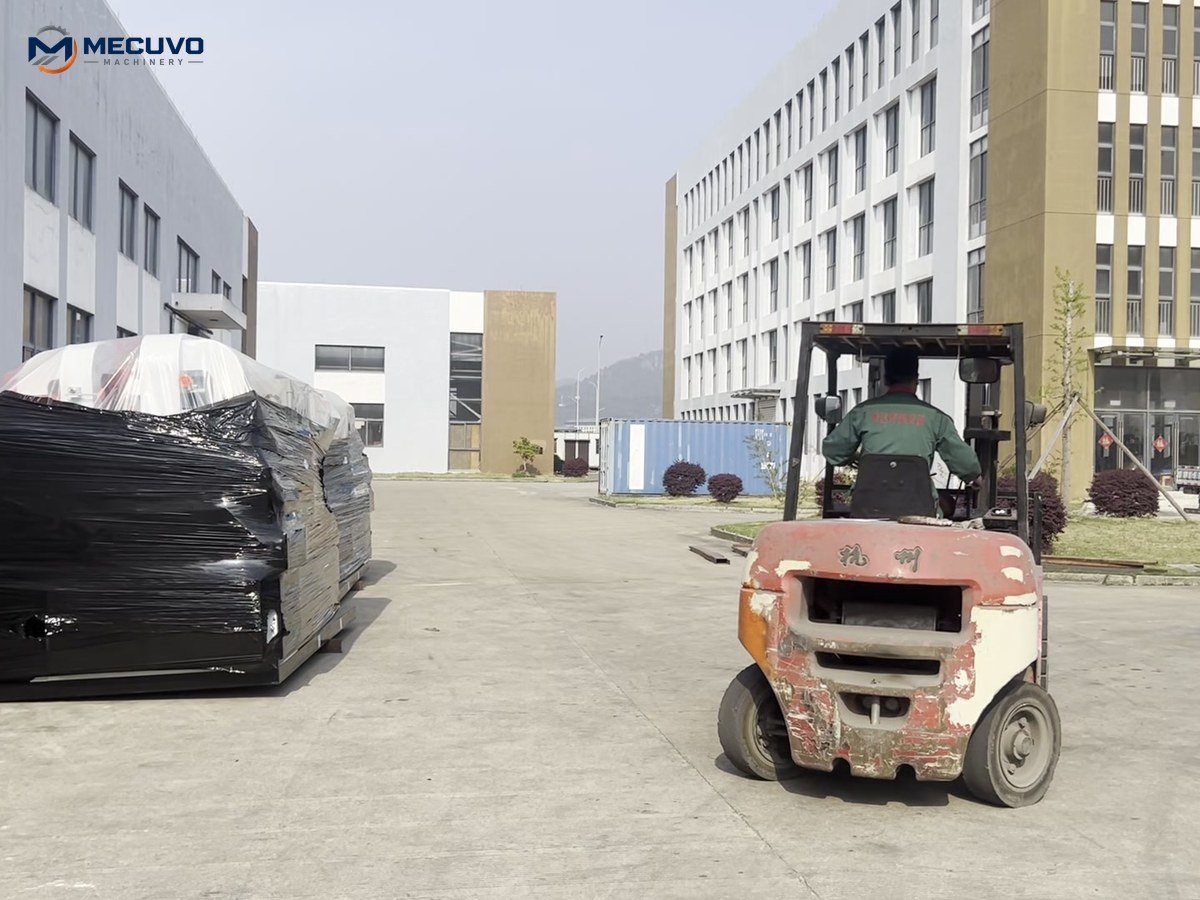 Wrapped granulator equipment beside a forklift before shipment