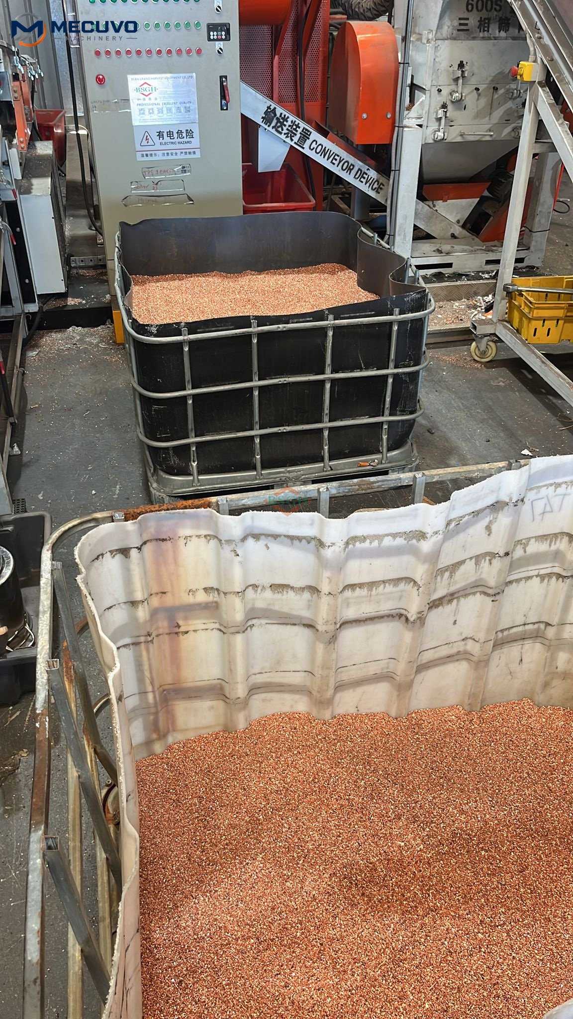 Recovered copper granules in collection containers beside recycling equipment, with MECUVO logo watermark